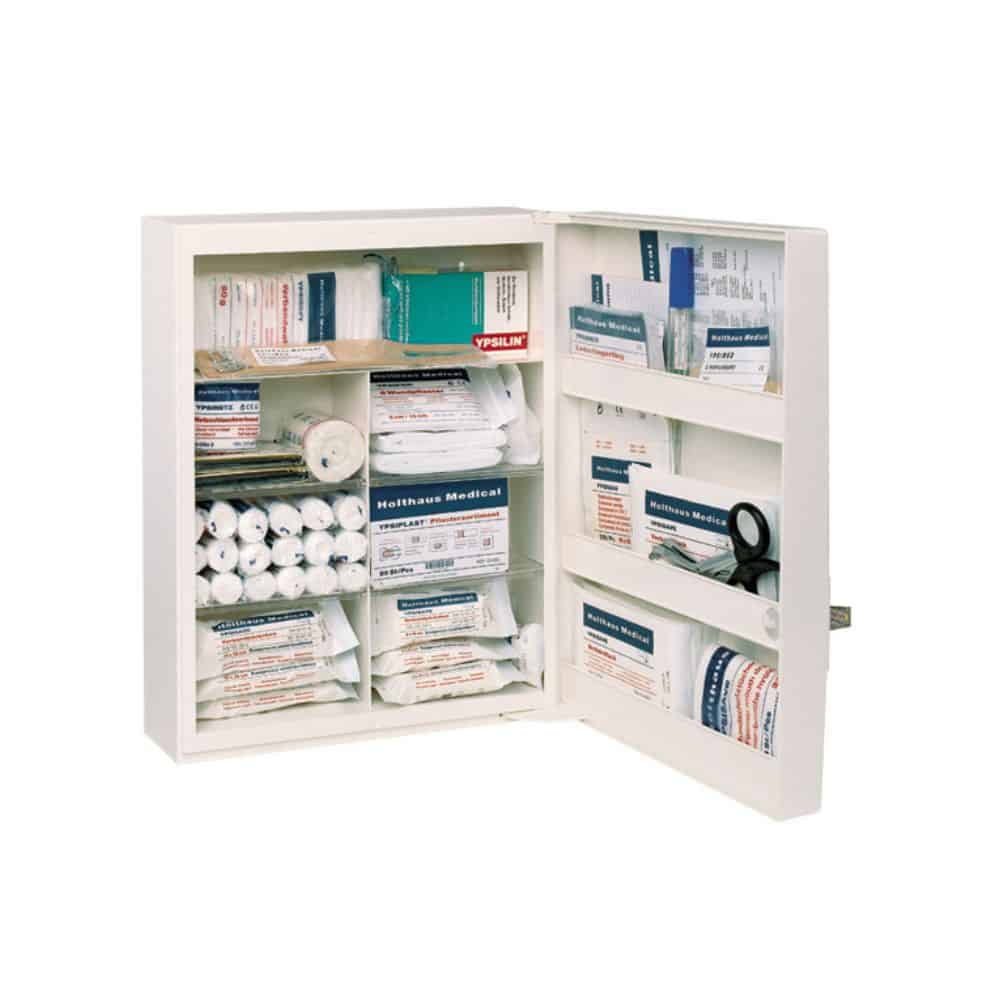 The Holthaus Medical FAMULUS First Aid Cabinet (unfilled) from Holthaus Medical GmbH & Co. KG is an open, spacious first aid cabinet with multiple shelves that can be stocked with various medical supplies such as bandages, gauze rolls, a CPR mask, antiseptic wipes, and adhesive bandages. Its clearly organized layout ensures easy identification and access in an emergency. A rescue symbol is clearly displayed on the door for quick recognition.