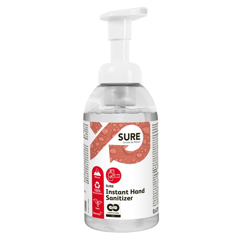 A transparent pump bottle labeled "SURE Instant Hand Sanitizer, hand disinfection" by Diversey Deutschland features red-white branding, symbols for recyclable packaging, and highlights the 100% plant-based ingredients for effective germ control.