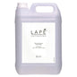 A 5-liter canister made of transparent plastic with a handle and screw cap from Diversey Deutschland GmbH & Co. OHG labeled "LAPE Earth Collection Sakura Sea Breeze Hand Wash" is provided with a white label and has a delicate scent of cherry blossoms and sea breeze.