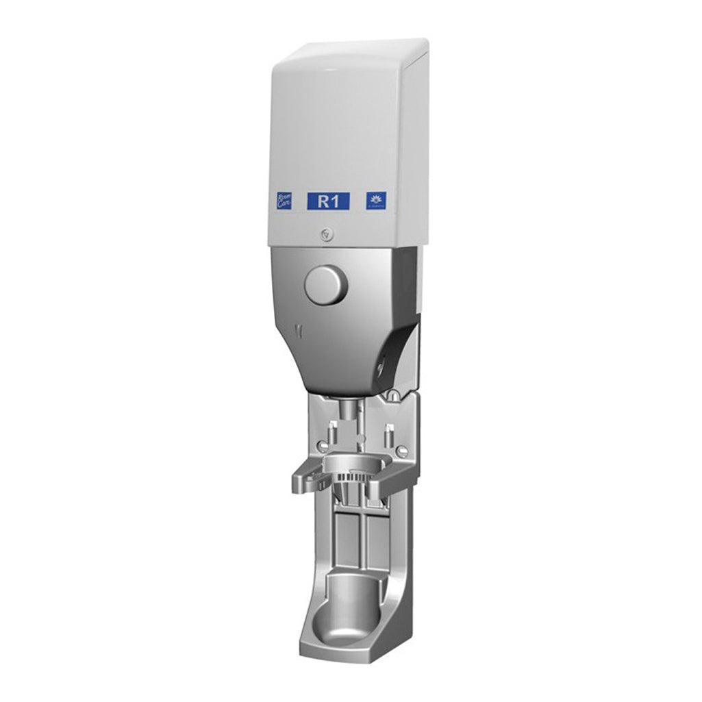 The DQFM system by Diversey Deutschland GmbH & Co. OHG is a wall-mounted soap or disinfectant dispenser made of stainless steel and white plastic, labeled "R1," with a push button and an integrated drip tray at the bottom.