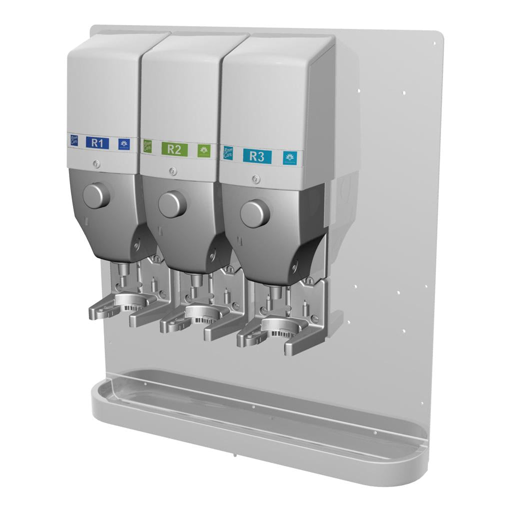 Three DQFM system dispensers (blue, green, blue), wall-mounted with a metal drip tray, pre-installed for low flow. Compatible with high concentrate for hygienic use. Brand: Diversey Deutschland GmbH & Co. OHG.