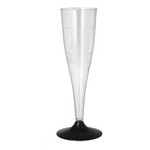 A clear Starpak champagne stem glass (0.1 l, Ø 5 cm, 17.5 cm) made of polystyrene with a black base stands upright on a white surface. The package contains six elegant glasses with subtle vertical text on the rim.