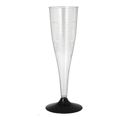 A clear Starpak champagne stem glass (0.1 l, Ø 5 cm, 17.5 cm) made of polystyrene with a black base stands upright on a white surface. The package contains six elegant glasses with subtle vertical text on the rim.