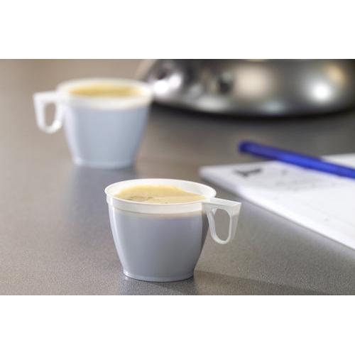 Two white Starpak 60 coffee cups (0.18 l, PS, Ø 7.8 cm, 6 cm), one in focus and one blurred in the background, are placed on a gray surface, with a pen and paper partially visible on the right side.