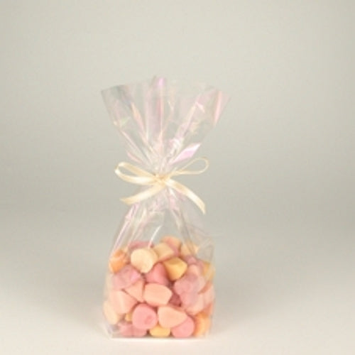 A Starpak 10 bottom bag, a transparent PP bag filled with pink and beige sweets and tied with a light ribbon, is centered against a simple light background.