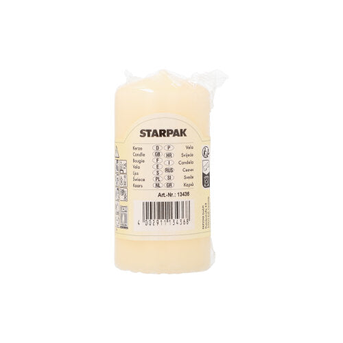 A white Starpak pillar candle with extra long burning time (Ø 50 mm, 100 mm) stands upright with a label reading “Candle” in various languages, a barcode, and product details.