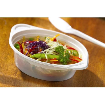 A Starpak 100 soup bowl, PP round, Ø 15.6 cm, contains a hearty vegetable soup with red pepper, cabbage, peas, and parsley garnish on a wooden table next to a white plastic spoon.