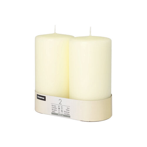 Two Starpak pillar candles Ø 80 mm with flat top stand in a simple cardboard holder with a label – a touch of timeless elegance for any ambiance.