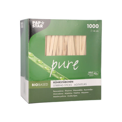 A green-white PAPSTAR "pure" box contains 1000 splinter-free, 14 cm long stirring sticks made of bio-based birch wood from PAPSTAR GmbH. The brand name appears at the top left of the packaging.