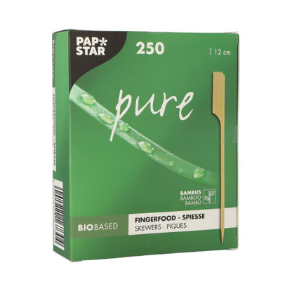 A green box labeled "PAPSTAR 250 Fingerfood - Skewers 'pure'" from PAPSTAR GmbH contains 250 bamboo skewers, each 12 cm long, perfect for party buffets. The package features a skewer, a green plant, and the inscriptions "Biobased" and "Bamboo".
