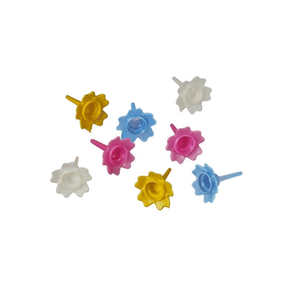 Nine colorful PAPSTAR holders for birthday candles from PAPSTAR GmbH are arranged on a white background - an ideal birthday cake decoration. Colorfully assorted, available in a 144-piece folding box.