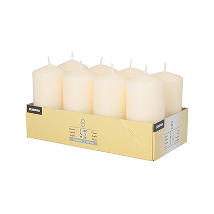 A yellow Starpak box contains 8 white pillar candles (Ø 50 mm, 100 mm), arranged in two rows of four each. Brand and product details are printed on the sides – ideal for your favorite candle holders.