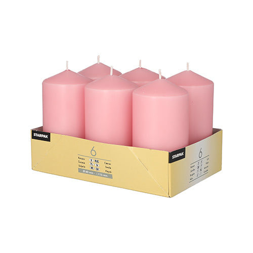 A yellow 'STAMPAK' tray holds six Starpak pillar candles (Ø 60 mm · 115 mm) in pink. These large, flat candles have visible wicks and offer a long burning time.