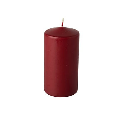 A single, unlit pillar candle from the Starpak brand (6 pillar candles, Ø 60 mm · 115 mm) made from high-quality wax with a white wick stands upright against a simple white background.