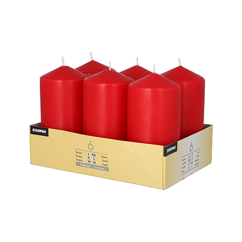 On a cardboard tray labeled 'Starpak' are six large Starpak pillar candles (Ø 60 mm, 115 mm) arranged in two rows of three, each candle characterized by a long burning time.