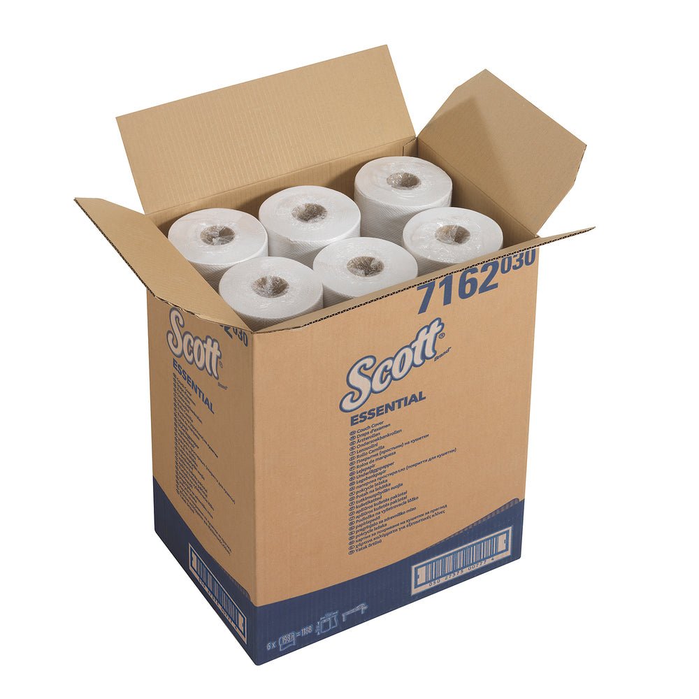 An open box labeled "Scott® ESSENTIAL™ medical rolls - White" by Kimberly-Clark GmbH contains six large white rolls, ideal as medical rolls for medical facilities, standing upright with visible roll ends.