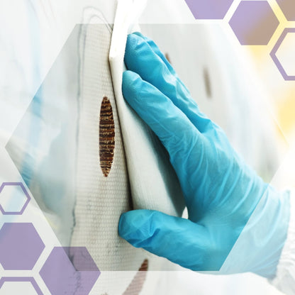 A hand in a blue glove cleans brown stains from a white surface with Kimberly-Clark GmbH Kimtech® Science precision wipes (200 sheets, white), ideal for sensitive surfaces. Hexagonal graphics appear in the corners of the image.