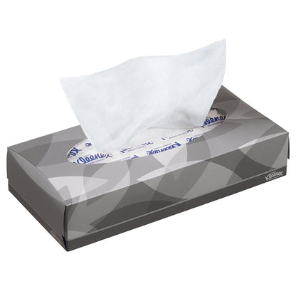 A rectangular gray box with Kleenex® facial tissues - Standard / White from Kimberly-Clark GmbH, from which a single white tissue is being pulled out. Subtle leaf pattern and brand text. Ideal for makeup removal or facial cleansing.