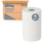 A box labeled "Kleenex® Roll Towels - E-roll Slimroll™ White 1-ply" from Kimberly-Clark GmbH is pictured next to a large white roll with a green core; a "6x" symbol indicates that the box contains 6 rolls, each 135 m long.