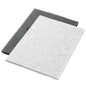 Two Twister Pads 14x20" White (35x51 cm) from Diversey Deutschland GmbH & Co. OHG, work step 1, lie flat on a white background: the white pad on top, slightly overlapping a dark gray pad. Ideal for professional applications.