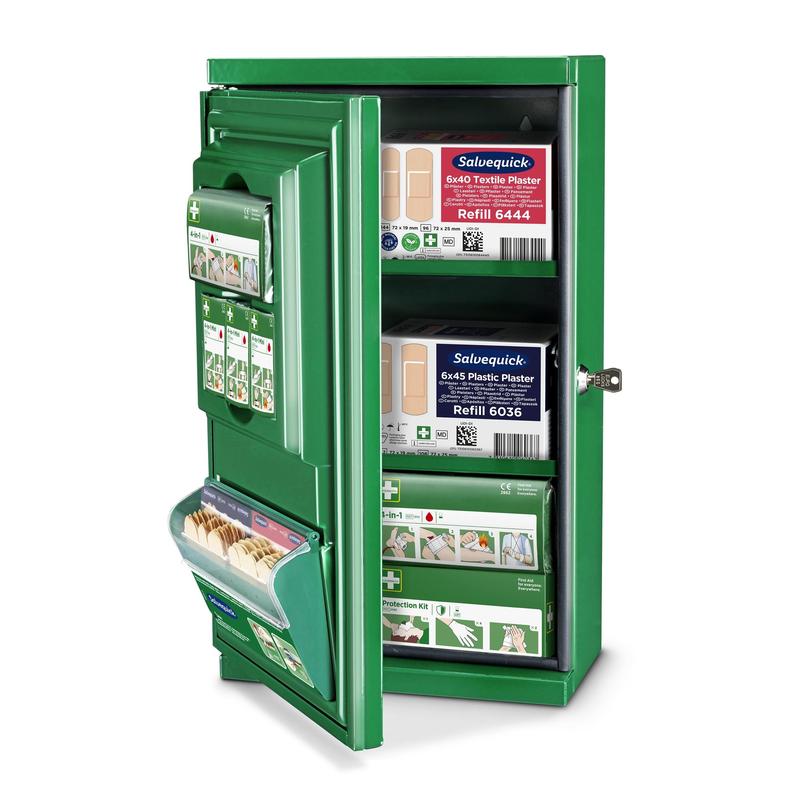 The green Cederroth First Aid Cabinet Mini (Metal) by Orkla Wound Care AB (W 260 x H 440 x D 170mm) is shown open, with a key in the lock and organized bandage packs, plasters, and first aid materials on its shelves.