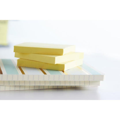 Three stacks of Post-it® Recycling Z-Notes (76x76 mm, 100 sheets/block, 100% PEFC) by 3M Deutschland GmbH rest on two striped notebooks in bright light with a gently blurred background.
