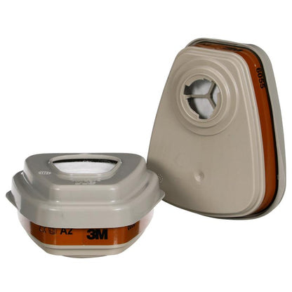 Two beige 3M™ Filter Set 6002-1SP A2P2 from 3M Deutschland GmbH with brown labels for organic vapor masks: one stands upright, the other lies flat showing its filter opening. The package contains 2x6055, 2x5925, 2x501.