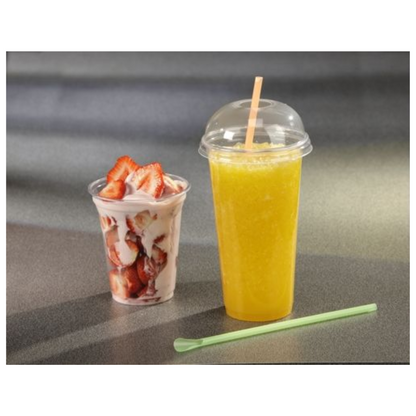 A Starpak plastic cup with sliced strawberries and whipped cream stands next to another Starpak plastic cup with a dome lid, containing a yellow smoothie. Next to it on the gray surface lies a light green straw.