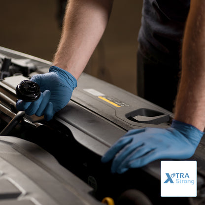 A person in ARNOMED NITRIL BLUE XTRA STRONG disposable gloves from ARNOWA GmbH opens a car hood. Only the upper body and arms are visible, the Xtra Strong logo is shown at the bottom right.