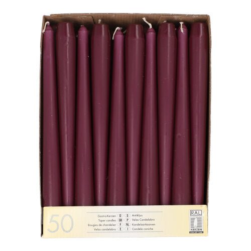 A cardboard box containing 50 chestnut-brown taper candles, each 25 cm long and 2.2 cm thick, arranged in a single row when viewed from above. The label reads "Starpak 50 Taper Candles Ø 2.2 cm–25 cm" with quantity information in several languages.