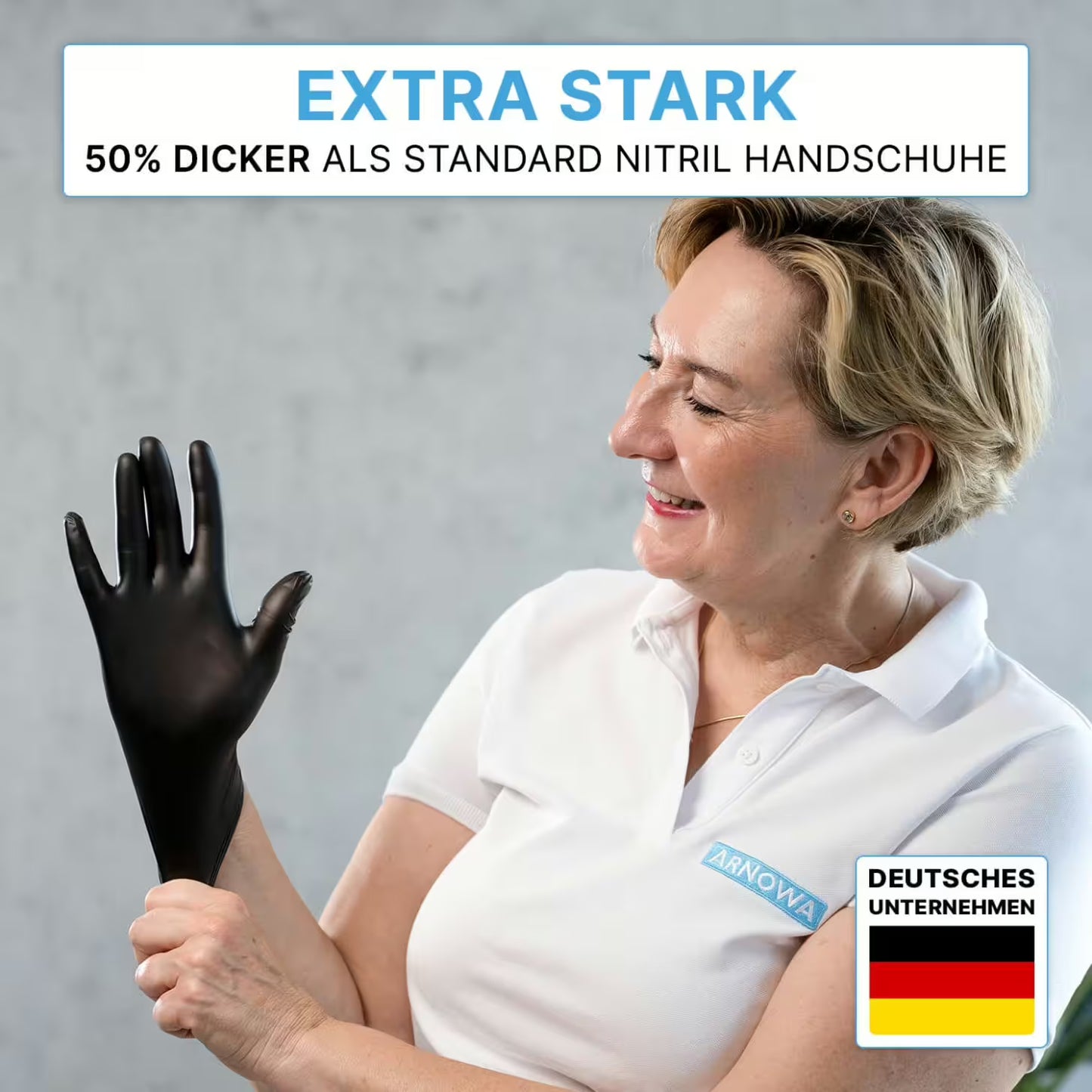 A person in a white polo shirt puts on ARNOMED NITRIL XTRA PURE BLACK skin-friendly & accelerator-free disposable gloves from ARNOWA GmbH. Text: "Extra strong, 50% thicker than standard nitrile". Bottom right: German flag and "German company".