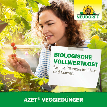 A woman in a garden inspects and picks small red berries. The image shows the Neudorff Shop logo and advertises Azet VeggieFertilizer, an organic plant fertilizer for house and garden plants.