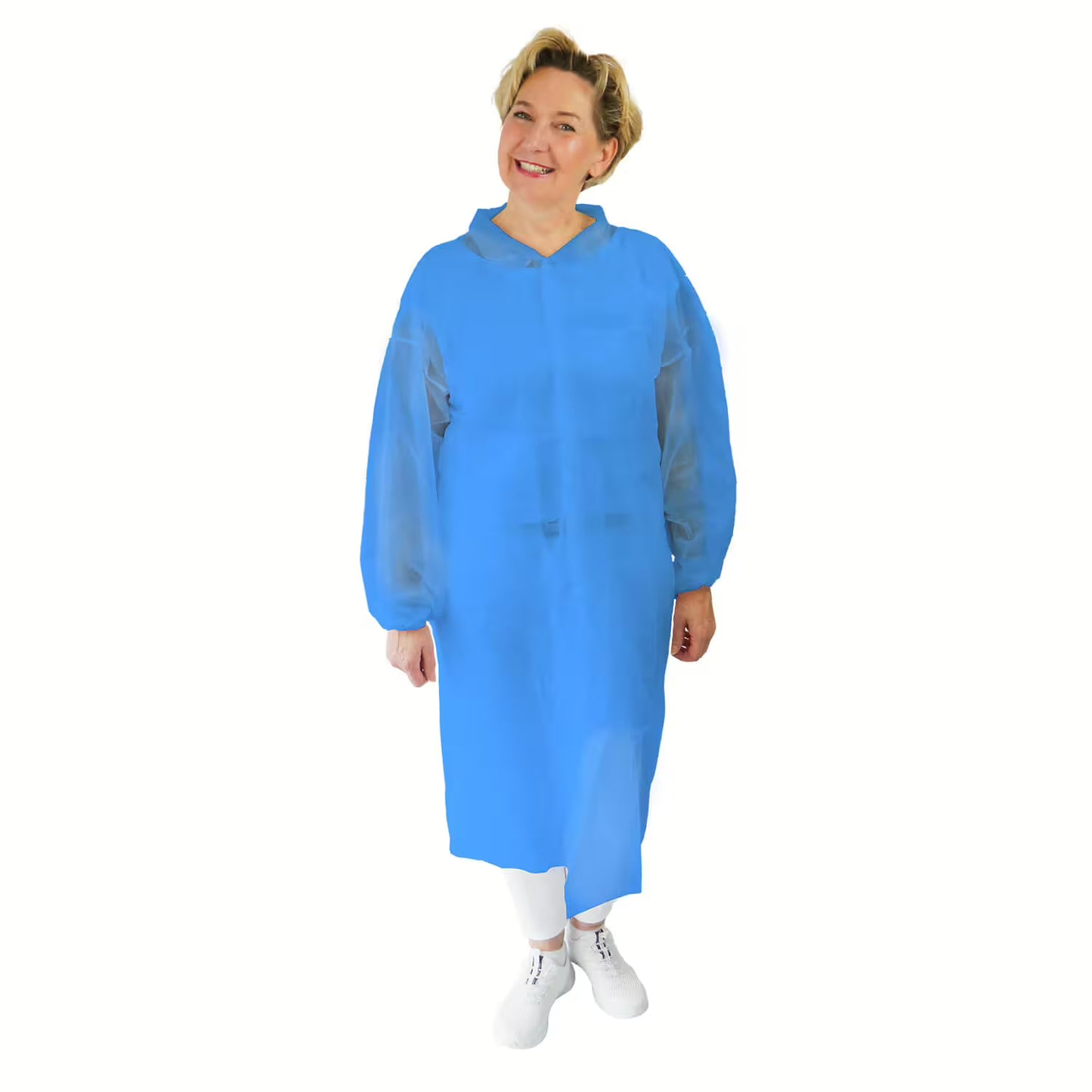 A person stands facing forward, smiling and wearing the ARNOMED PROTECT PP-VISITOR GOWN BLUE disposable visitor coat with snap buttons from ARNOWA GmbH, paired with white pants and shoes. The background is solid white.
