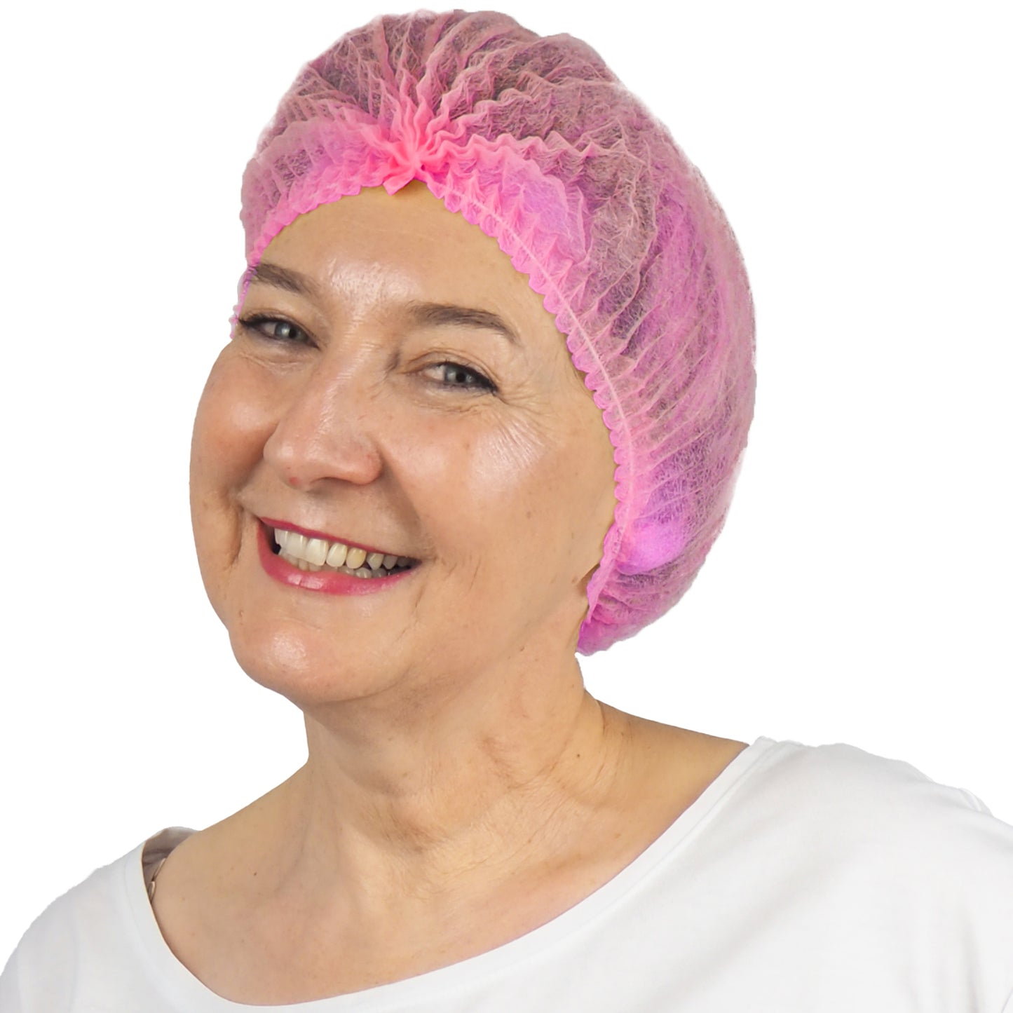 A smiling older woman wears an ARNOMED COVER PP CLIP CAP disposable clip cap made of PP fleece (52cm) from ARNOWA GmbH and a white top, posing against a simple white background.