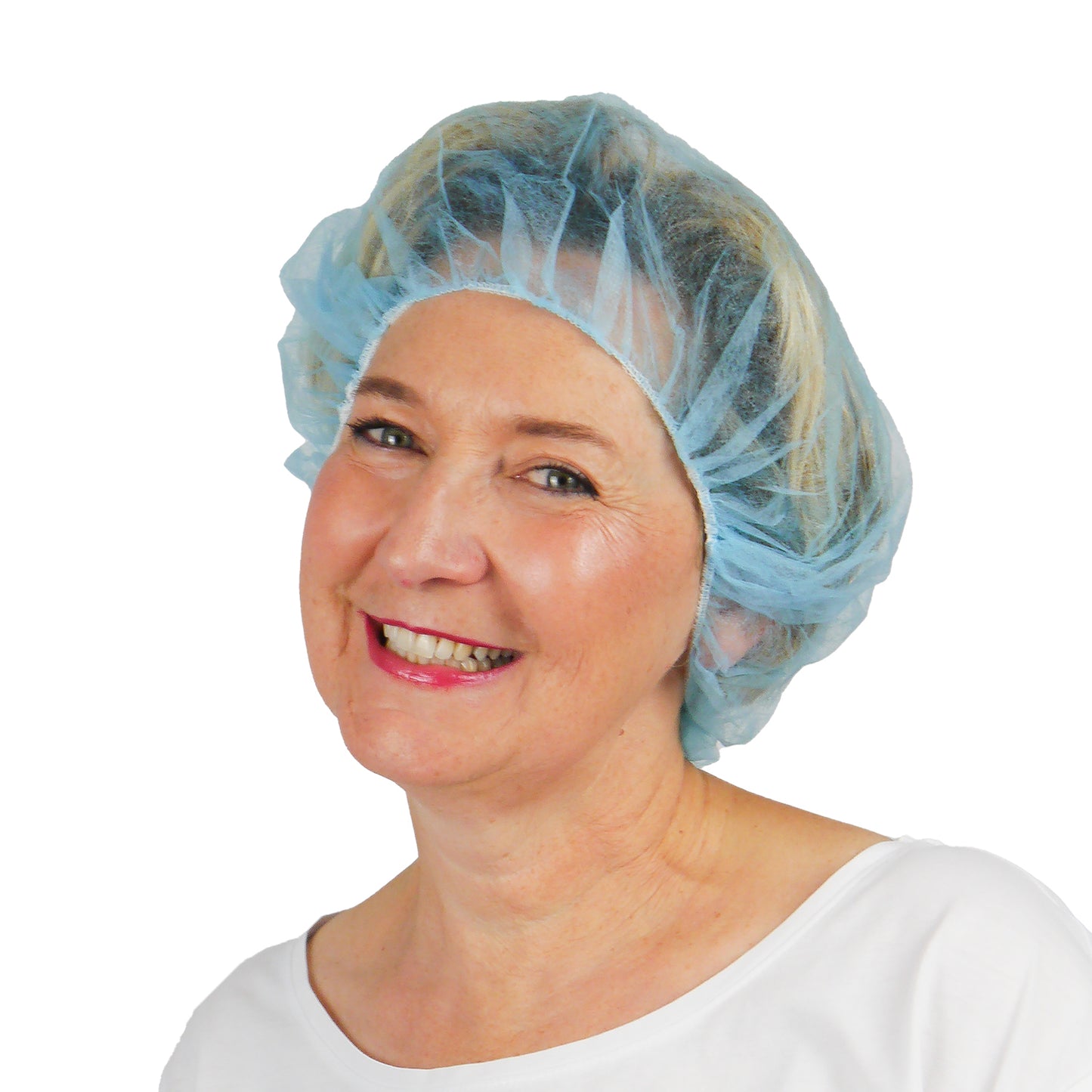 A woman in a light blue ARNOMED COVER PP-BARETTHAUBE bouffant cap made of PP non-woven fabric by ARNOWA GmbH and a white top smiles in front of a plain white background, highlighting this hygienic accessory for the hygiene sector.