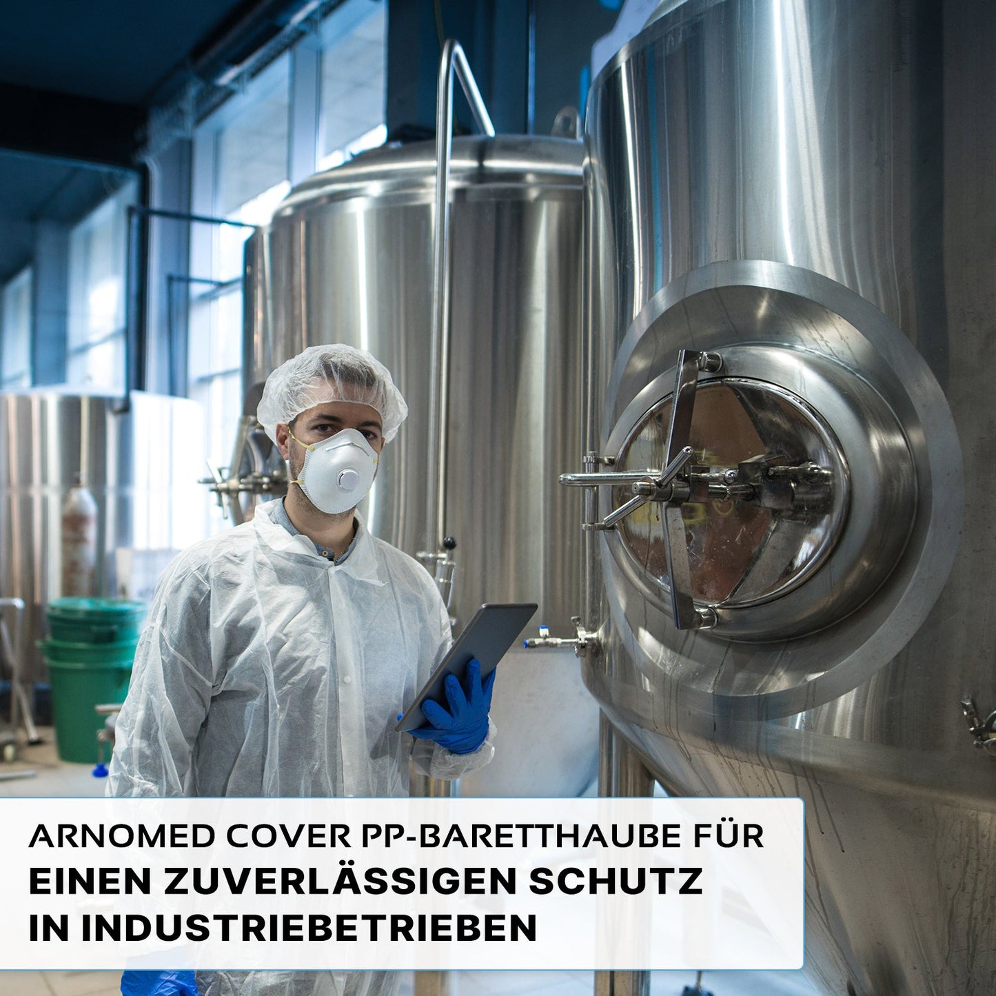 A person in protective clothing, including the ARNOMED COVER PP-BARETTHAUBE by ARNOWA GmbH and a mask, holds a tablet next to stainless steel tanks in a hygienic industrial area. The German text about reliable protection is displayed below.