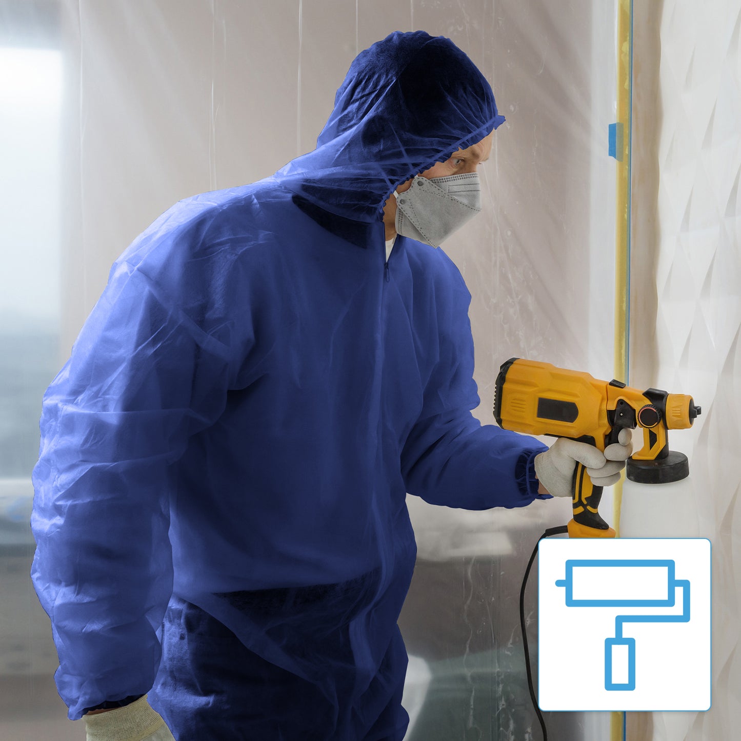 A person in an ARNOMED COVERALL PP-OVERALL BLUE disposable overall with a hood from ARNOWA GmbH and gloves uses a yellow paint sprayer indoors, with plastic sheeting in the background and a paint roller symbol at the bottom right.