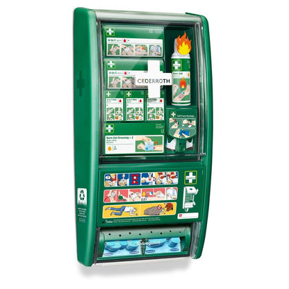 The Cederroth first aid & burn station from Orkla Wound Care AB contains bandages, burn gel, dressings, plasters, illustrated instructions, labeled compartments, and a plaster dispenser in a green station.