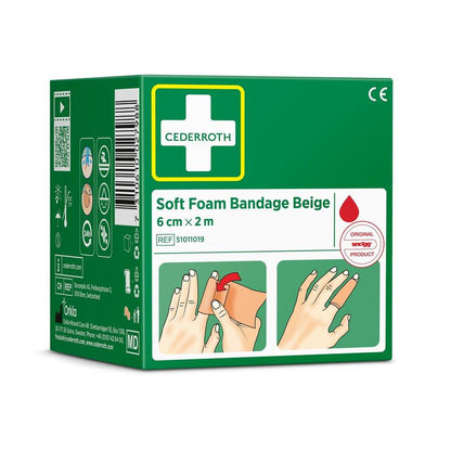 A green box with the inscription "Cederroth soft foam bandage beige 6 cm x 2m | Package (1 piece)" from Orkla Wound Care AB shows images of hand bandages, a red drop symbol, symbols, and side contact information.