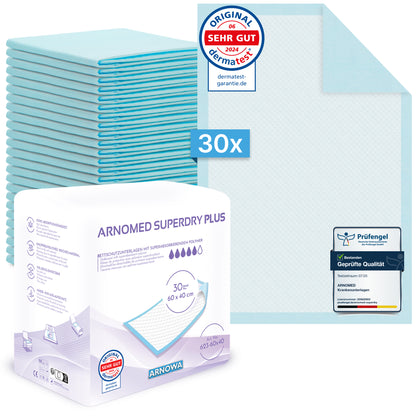 A stack of 30 blue ARNOMED SUPERDRY PLUS extra absorbent medical pads with SAP from ARNOWA GmbH is shown next to the packaging with visible certification and quality seals; a super absorbent pad is visible in the upper right corner.