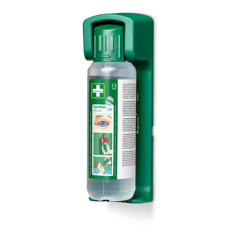A green Orkla Wound Care AB wall mount contains a 500 ml eye wash bottle with a green cap, the inscription "Eye Wash" and usage instructions; including a glow-in-the-dark sign. The package contains 1 wall mount for emergency eye wash stations.