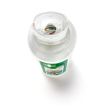 Close-up of a bottle of Cederroth Eye Wash 2 x 500 ml (2-pack) from Orkla Wound Care AB from above, with a transparent flip-top cap and a green-white label indicating use in eye accidents. Part of the label is visible through the opening of the cap.