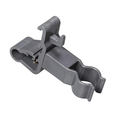 The TASKI accessory holder from Diversey Deutschland GmbH & Co. OHG is a gray plastic clip with two round openings and a locking hinge. It is used for securely fastening cylindrical cleaning tools and organizing cleaning accessories. Smooth surface, angled details.