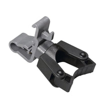 A close-up of the TASKI handle holder with clamp from Diversey Deutschland GmbH & Co. OHG, compatible with the cloth box holders 7517270 or 757371, with a gray attachment and black spring clamp on a white background.