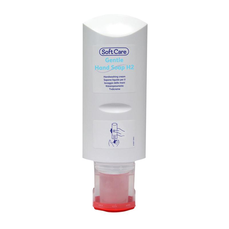 An upright, white Soft Care hand soap dispenser from Diversey Deutschland GmbH & Co. OHG with a red base. The label shows the product name, gentle cleaning instructions, and a blue line drawing of a hand using the dispenser.