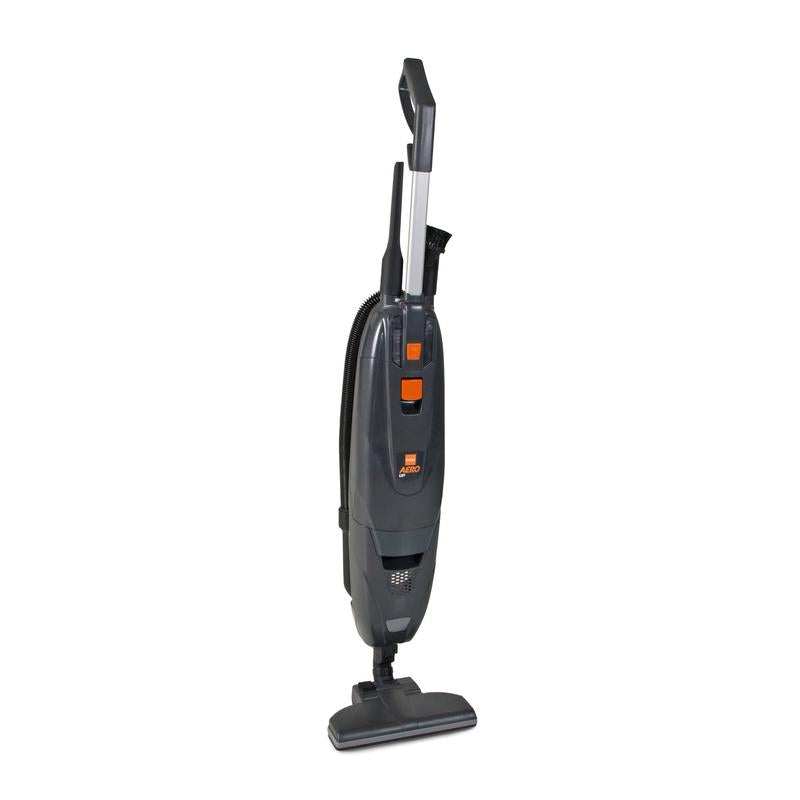 The TASKI AERO UP Li-Ion from Diversey Germany is a black, upright, battery-powered brush vacuum with a telescopic tube, two orange top buttons, a rectangular base, and a handheld suction for small to medium areas - including a brush and crevice nozzle.