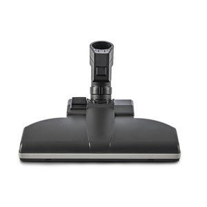 The TASKI Aero UP standard nozzle from Diversey Deutschland GmbH & Co. OHG is a black floor attachment with a rectangular base and central connection, perfect for commercial areas. Suitable for the TASKI Aero UP, package (1 piece), shown front view on a white background.