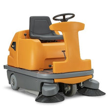 The TASKI balimat 6500 RTU from Diversey is a battery-operated, robust ride-on sweeper with 2 roller brushes, side brushes, 4x180 Ah batteries, and charger - ideal for the efficient cleaning of large areas.