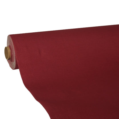 A roll of deep red tablecloth Tissue 'ROYAL Collection' by PAPSTAR GmbH is partially unrolled on a cardboard roll. The high-quality tissue ensures a smooth, opaque appearance.