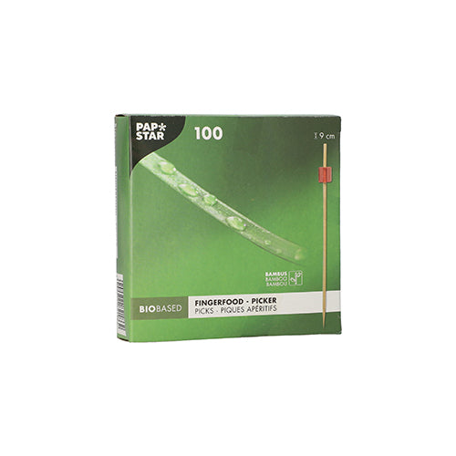 The green box "PAPSTAR 100 Fingerfood - Picker" by PAPSTAR GmbH contains 100 bamboo picks each 9 cm long. The bio-based packaging shows a pick with a red tip, ideal for serving finger food skewers at any event.